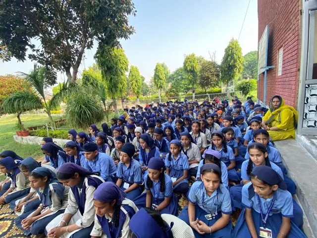 Pupils gathered outdoors at the school