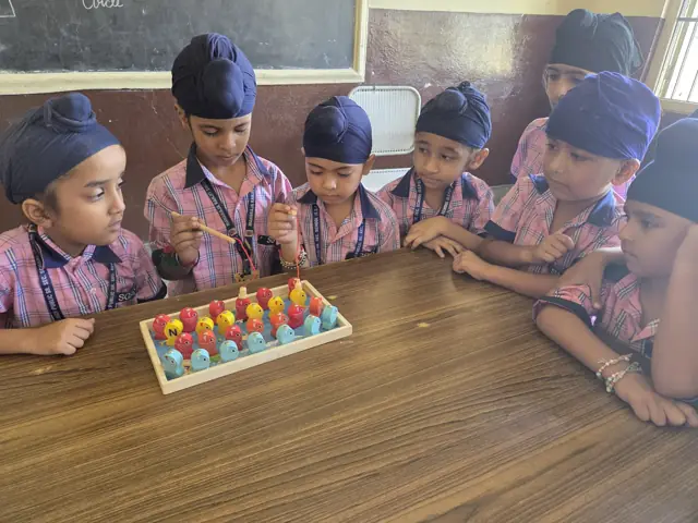 Young pupils learning together with an abacus
