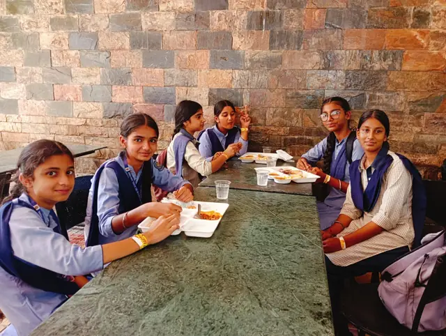 Pupils working together around a classroom table